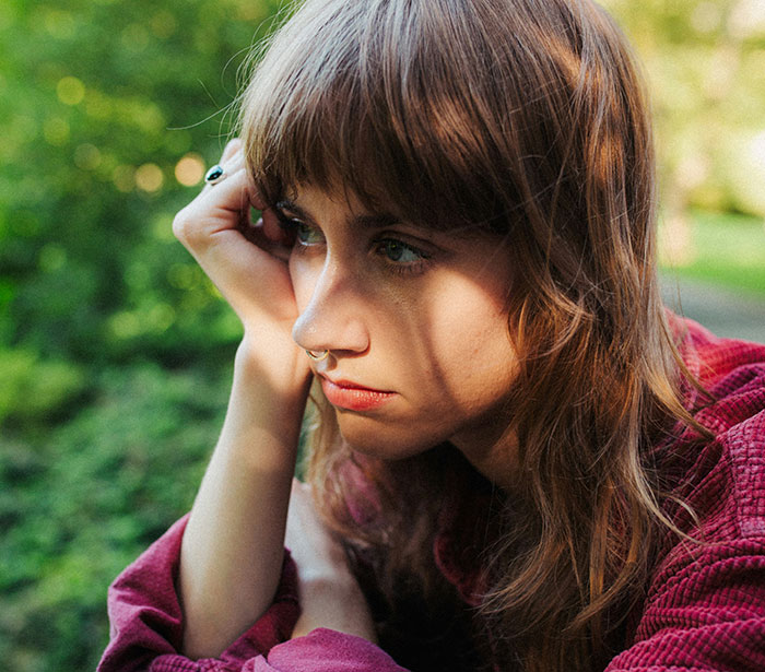 Woman looking thoughtful and concerned outdoors, reflecting on man’s slow change in behavior affecting their marriage. Woman looking thoughtful and concerned outdoors, reflecting on man’s slow change in behavior affecting their marriage.