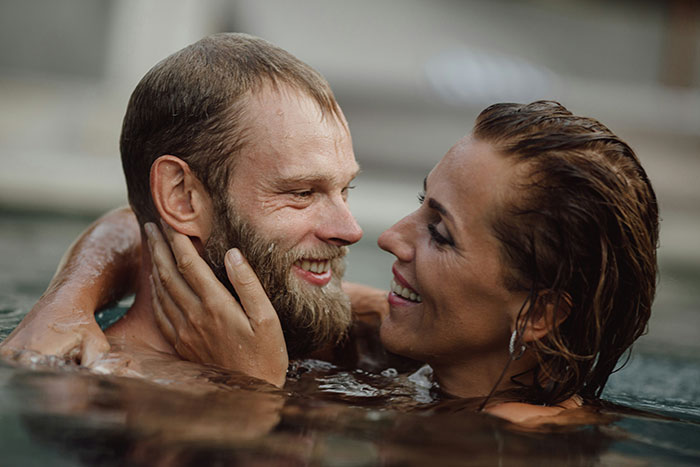 Couple in a pool sharing an intimate moment as wife questions slow change in her husband’s behavior and their marriage. Couple in a pool sharing an intimate moment as wife questions slow change in her husband’s behavior and their marriage.