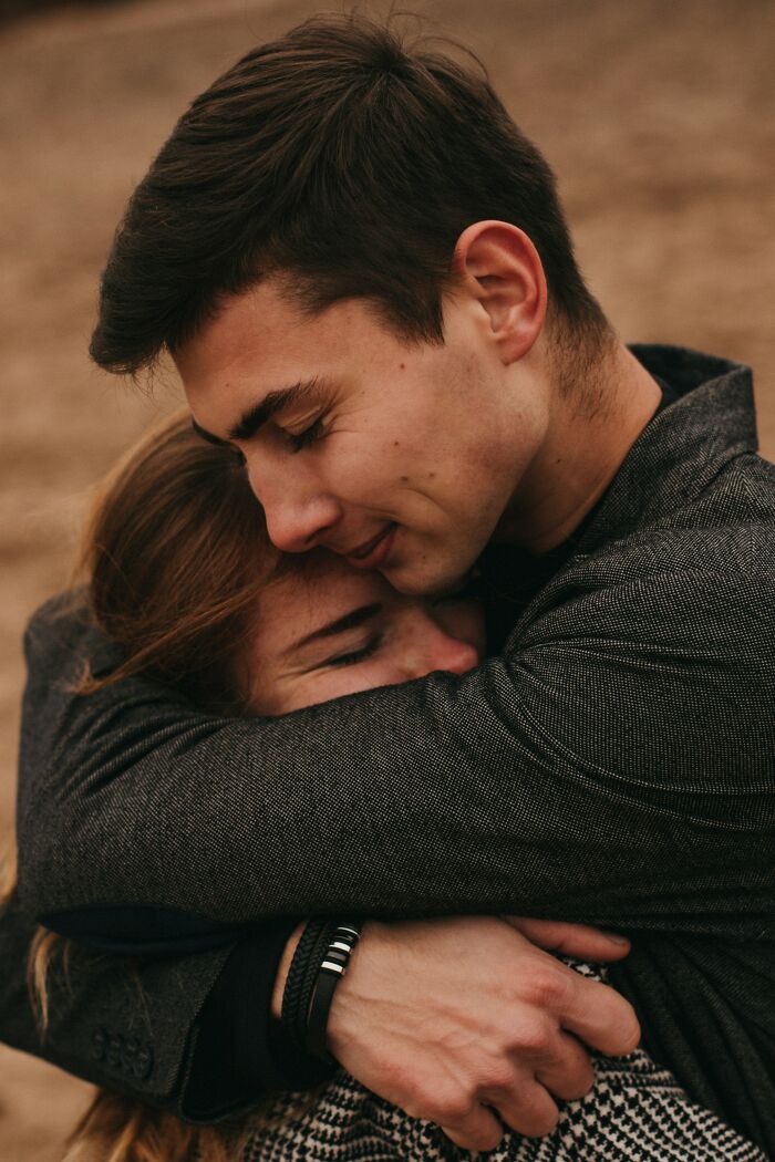 Young man and woman hugging outdoors, illustrating awkward moments when nice guys turn creepy in relationships.