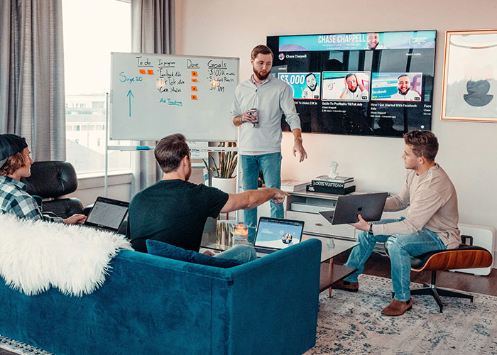Young professionals in a modern office setting having a meeting about work behavior and productivity goals.