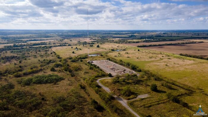 Aerial view of abandoned site in vast, overgrown landscape, capturing eerie atmosphere for abandoned explorers encounters.