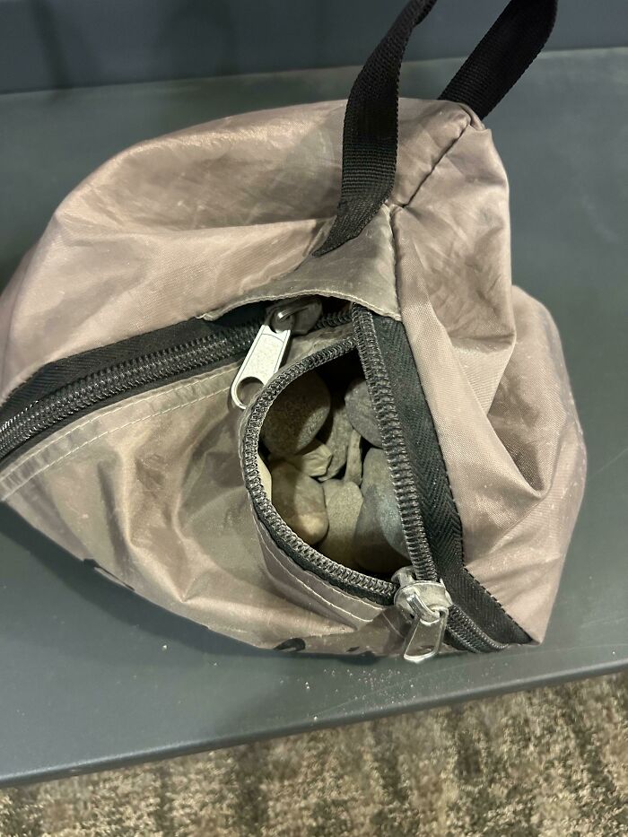 Small pouch with stones inside on a table representing unexpected problems for airport security screening.