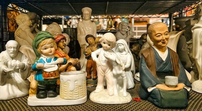 A collection of vintage ceramic figurines displayed on a shelf, highlighting industries affected by Millennials.