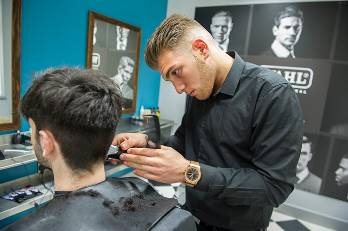 Barber giving a haircut in a modern barbershop, highlighting boomers breaking into barbershop incident. Barber giving a haircut in a modern barbershop, highlighting boomers breaking into barbershop incident.