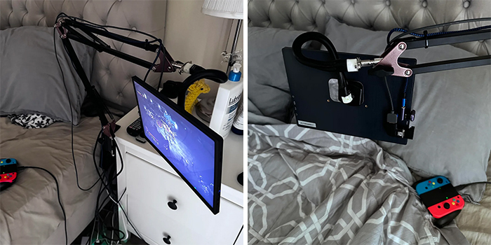 Creative redneck engineering setup with a TV and tablet mounted on adjustable arms next to a bed with gaming controllers.