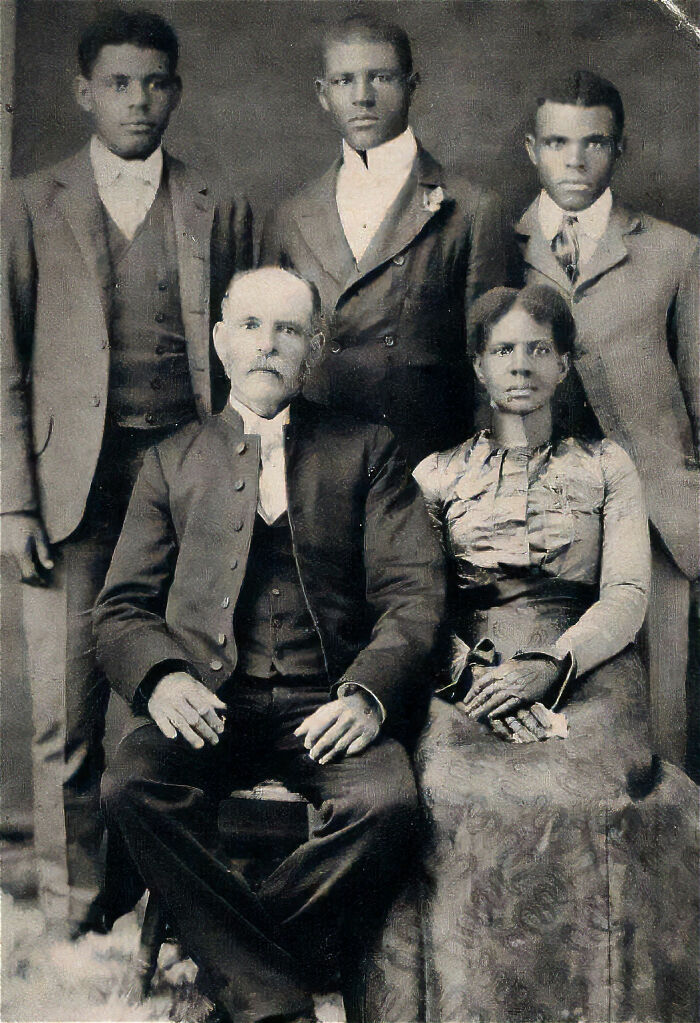 Vintage black and white photo of a family in formal attire, showcasing unique old photos with incredible stories behind them.