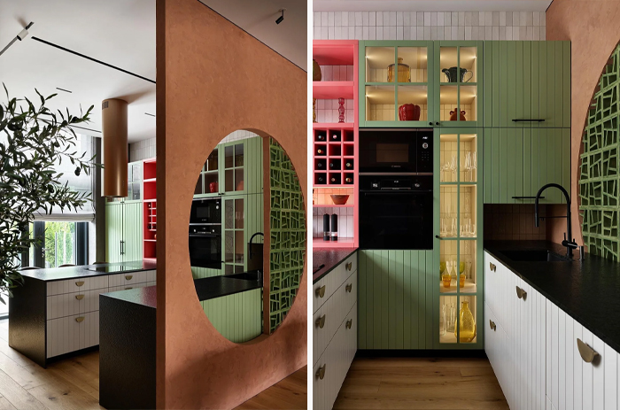 Modern kitchen revamp with green and white cabinets, black countertops, and open shelving showcasing glassware and decor.