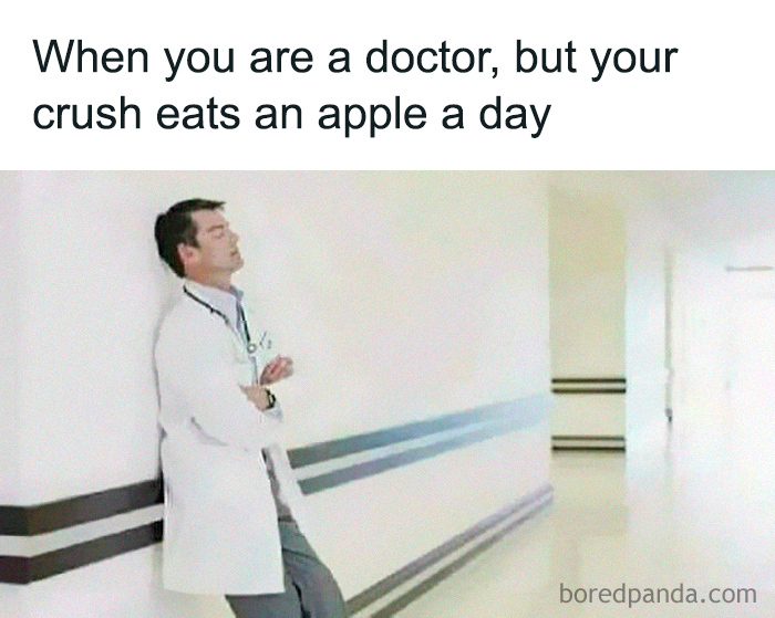 Doctor leaning on hospital wall with arms crossed, caption about being a doctor when crush eats an apple a day medical meme