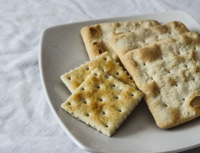 Plate with plain square crackers, representing unexpected moments related to wedding invitation regrets. - 3