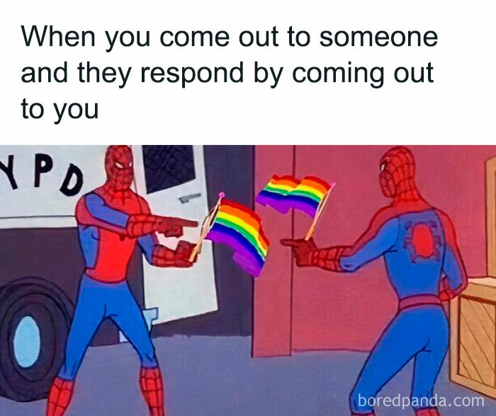 Two Spiderman characters pointing at each other while holding rainbow LGBTQ+ flags, meme about coming out.