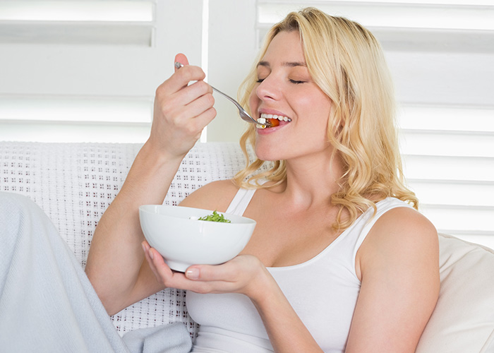 Blonde woman enjoying food at home, representing former employees revealing crazy secrets from their time working. - 12