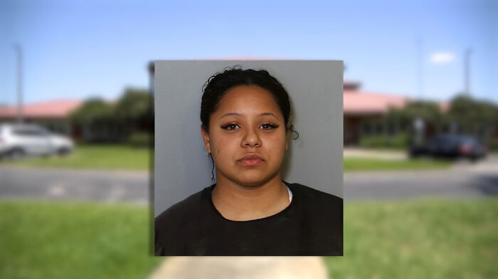 Mugshot of a woman facing consequences of her own stupidity, related to losing jobs and personal mistakes.