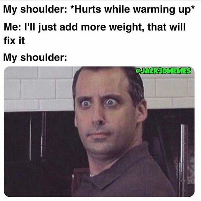 Man with wide eyes reacting humorously to shoulder pain while lifting weights, gym memes for fitness enthusiasts.