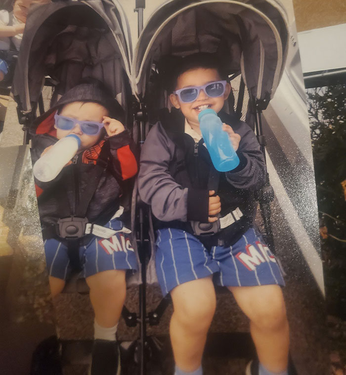 Two young boys wearing sunglasses, sitting in a double stroller drinking from bottles, main SEO keywords car baby lost life. - 14
