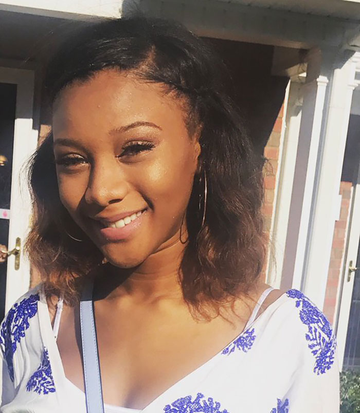 Young woman smiling outdoors, associated with former reality TV child star attacking Walmart shopper with sock full of rocks.