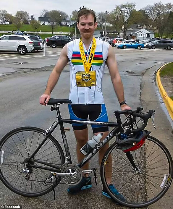 Man in cycling gear holding a bike with a medal around his neck, illustrating consequences of stupidity and job loss.