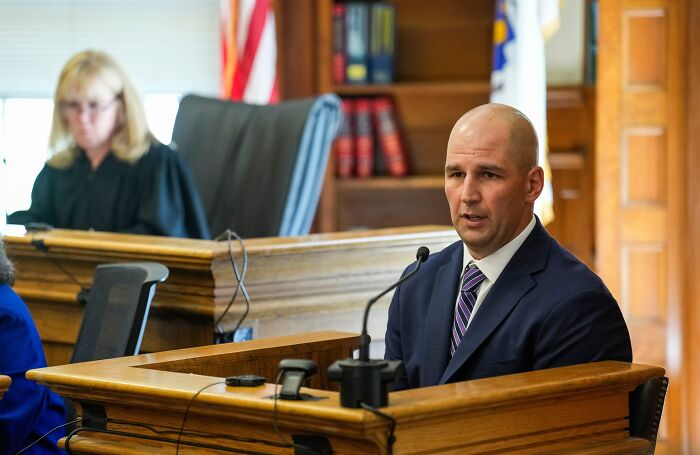 Man in suit speaking in courtroom, illustrating consequences faced by people who lost their jobs due to their own mistakes.