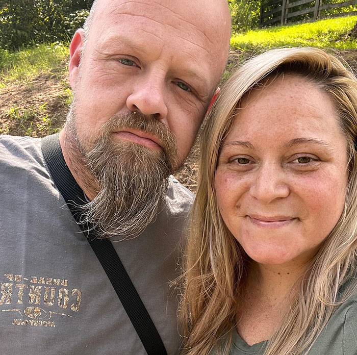 Couple outdoors posing for a close-up photo, related to girl finding parents' bodies and unaware sister shooter story.