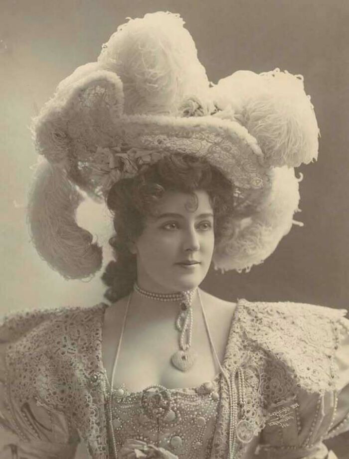 Vintage portrait of a woman in an elaborate hat and lace dress, showcasing unique old photos and their incredible stories.