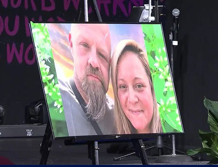 Photo of a portrait of parents displayed at a memorial related to a girl finding parents' bodies at home.