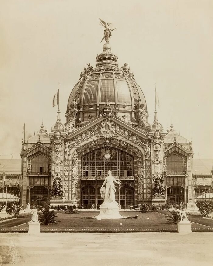 Ornate old architecture featuring a grand domed building with detailed sculptures and statues in front.