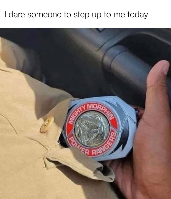 Hand holding a Mighty Morphin Power Rangers morphing device, evoking nostalgia for 90s childhood memories.