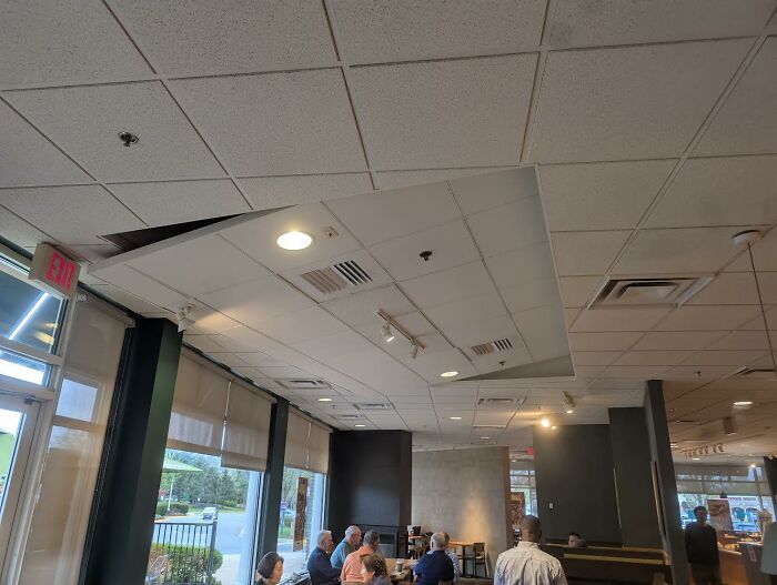 Ceiling installation fail in a commercial space showing misaligned panels in a creative home design attempt.