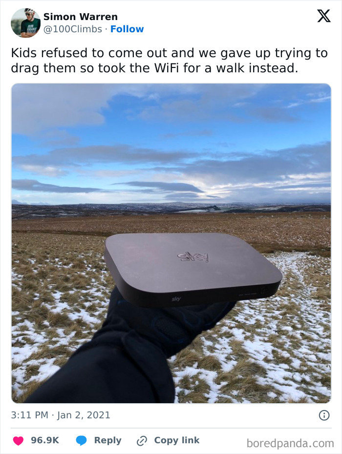 Dad humor shown by a father holding a WiFi box outdoors after kids refused to come out, nailing hilarious fatherhood moment.