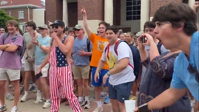 A group of young people cheering and reacting outdoors, illustrating moments people faced consequences of stupidity and job loss.