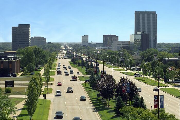 Wide view of a busy city street with buildings and greenery showcasing one of the best places to live in the USA.