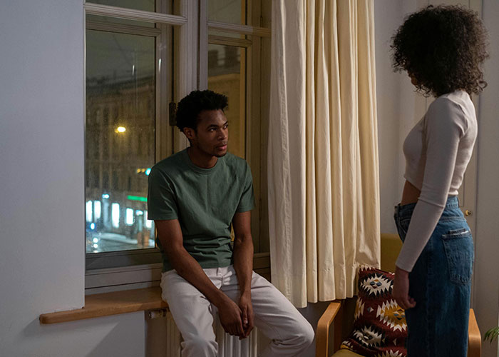 Young couple in a tense conversation at night, illustrating emotional conflict in worst cheating stories.