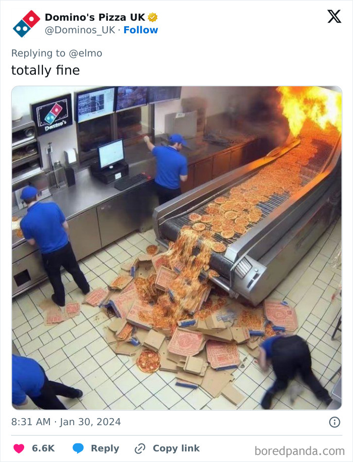 Domino’s Pizza employees working by a conveyor belt with pizzas spilling out and a large flame in the kitchen area. Domino’s Pizza employees working by a conveyor belt with pizzas spilling out and a large flame in the kitchen area.