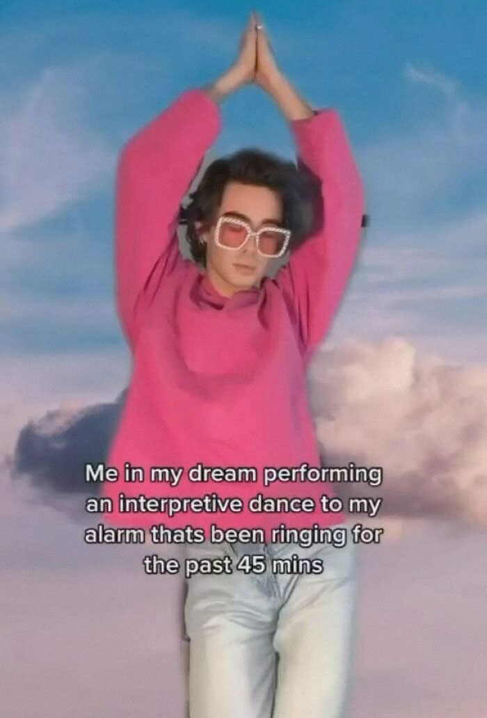 Person in pink sweater and sunglasses posing with hands raised, relatable friendship meme humor about alarm ringing in dream.