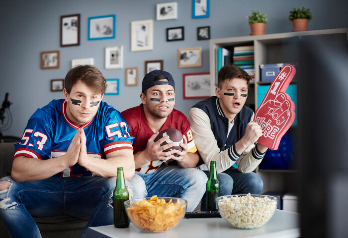Three young men watching football at home, showing typical habits that some netizens find really creepy. - 4