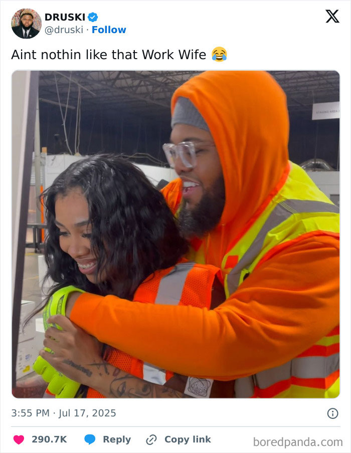Man in orange hoodie and woman in safety vests smiling and hugging, sparking Chris Martin CEO affair memes.