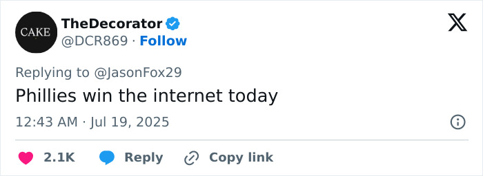 Baseball mascot making a humorous gesture during a game, playfully mocking disgraced CEO in a public moment.