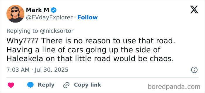 Screenshot of a Twitter reply discussing Oprah refusing to open her private road during an oncoming tsunami chaos debate.