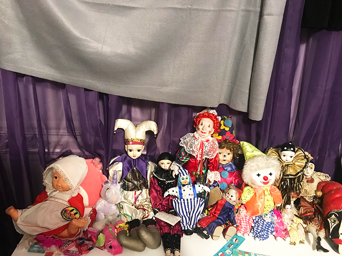 A man’s huge clown collection with various colorful clown dolls and figurines displayed on a shelf. A man’s huge clown collection with various colorful clown dolls and figurines displayed on a shelf.