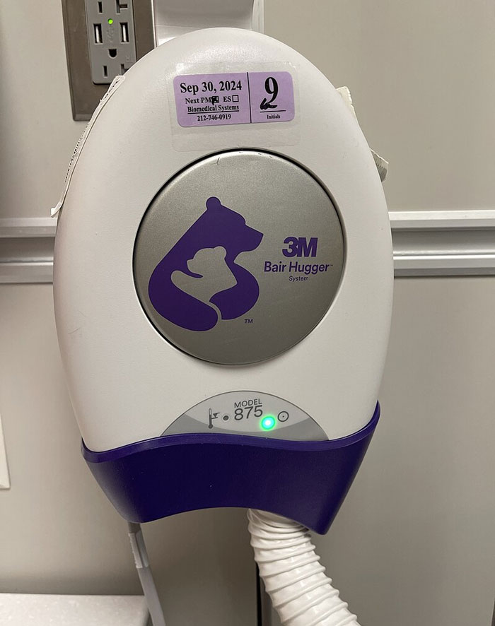 Medical warming device plugged in on hospital wall, highlighting common hospital mistakes with equipment use and maintenance.