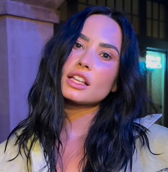 Demi Lovato with long black hair and neutral makeup in a casual jacket, fans horrified by shocking x-rated admission. Demi Lovato with long black hair and neutral makeup in a casual jacket, fans horrified by shocking x-rated admission.