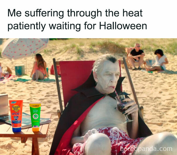 Man dressed as a vampire sitting on a beach chair drinking a cold drink, illustrating funny summer memes about heat suffering.