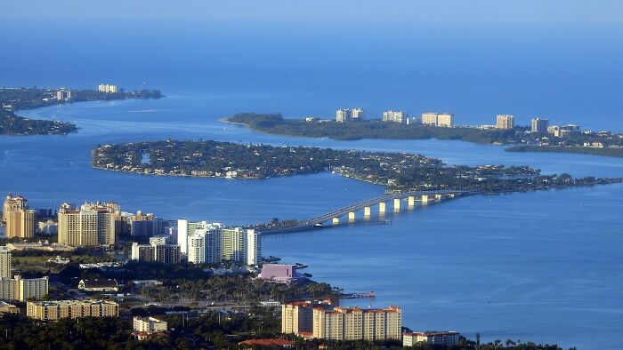 Aerial view of coastal city with bridges and high-rise buildings among the best places to live in the USA.
