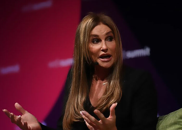 Female speaker with long brown hair in a black outfit discussing controversial moments involving the KarJenner clan on stage. - 30