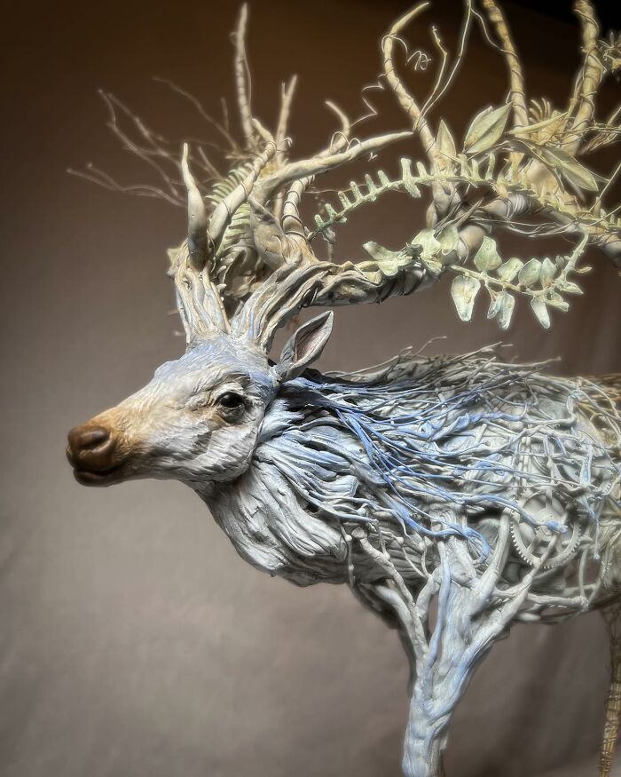 Intricate animal sculpture made from scrap metal featuring a detailed deer with elaborate antlers.