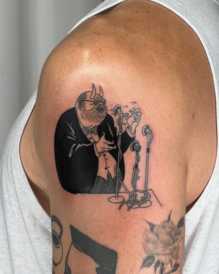 Tattoo of a cartoonish man with horns singing into vintage microphones on an arm, unique best tattoos design.