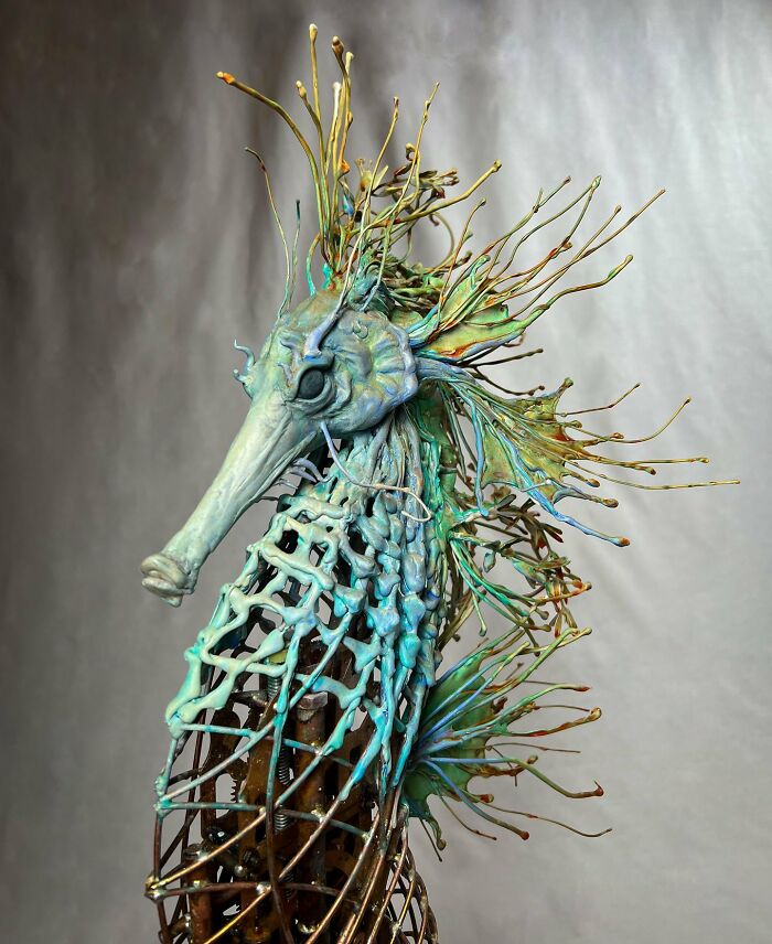 Seahorse sculpture made from scrap metal showcasing striking animal art with intricate details and vibrant colors.