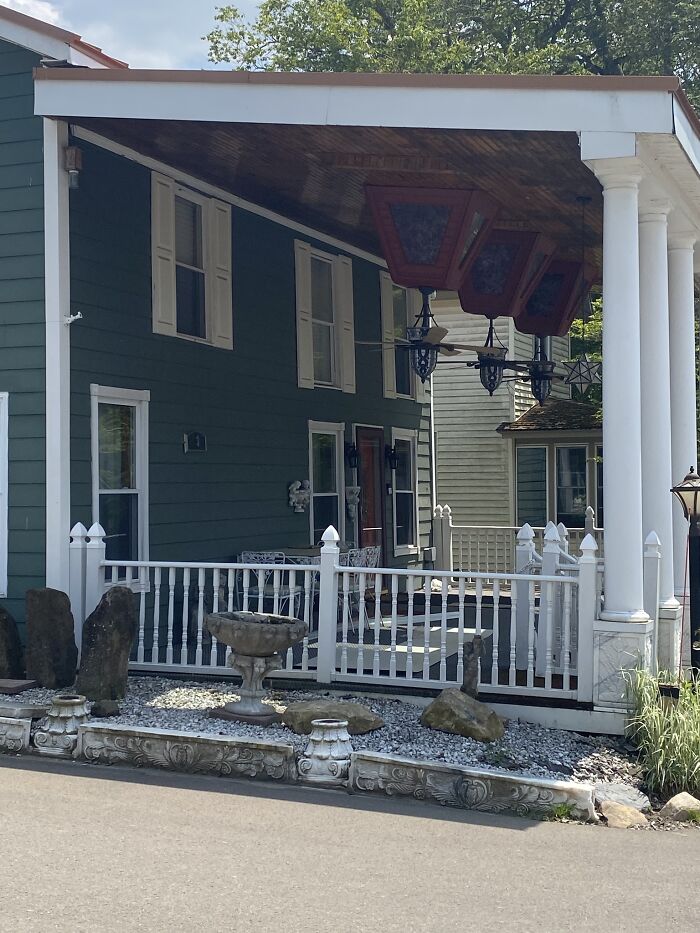 Home with upside-down porch ceiling and hanging lamps, showcasing a creative home design fail in outdoor decor.