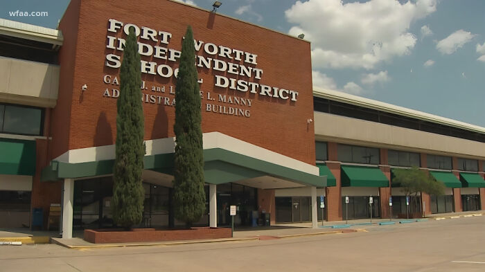 Fort Worth Independent School District administrative building under a partly cloudy sky, representing job consequences and loss.