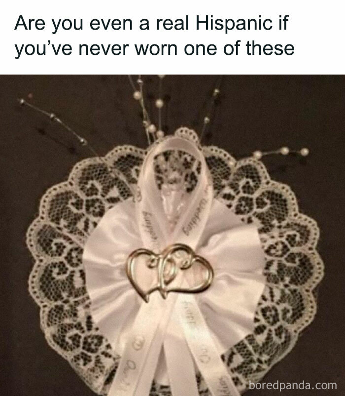 White lace and ribbon wedding accessory with pins, illustrating a funny meme about Hispanic culture experiences.