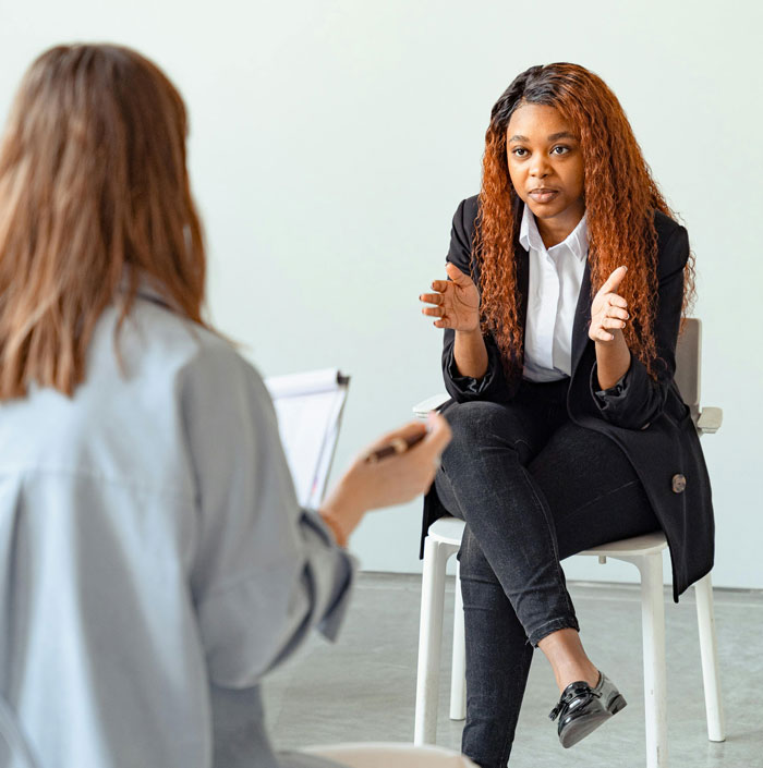 Therapist in a counseling session discussing differences between men and women with a client in a modern office setting - 22